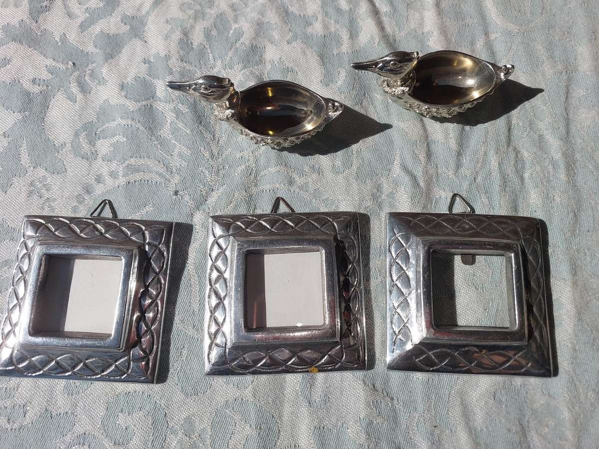 A COLLECTION OF PEWTER PHOTO FRAMES, FIGURINES  AND TWO SILVER PLATE DUCK SALTS