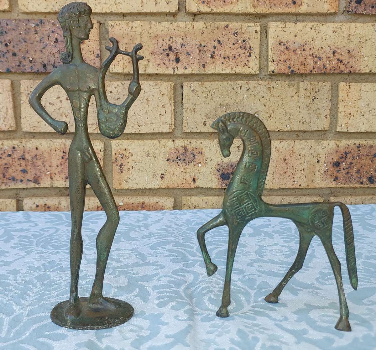 A vintage Mid Century Modern Inspired Metal Etruscan Horse and a nude Greek musician sold as is