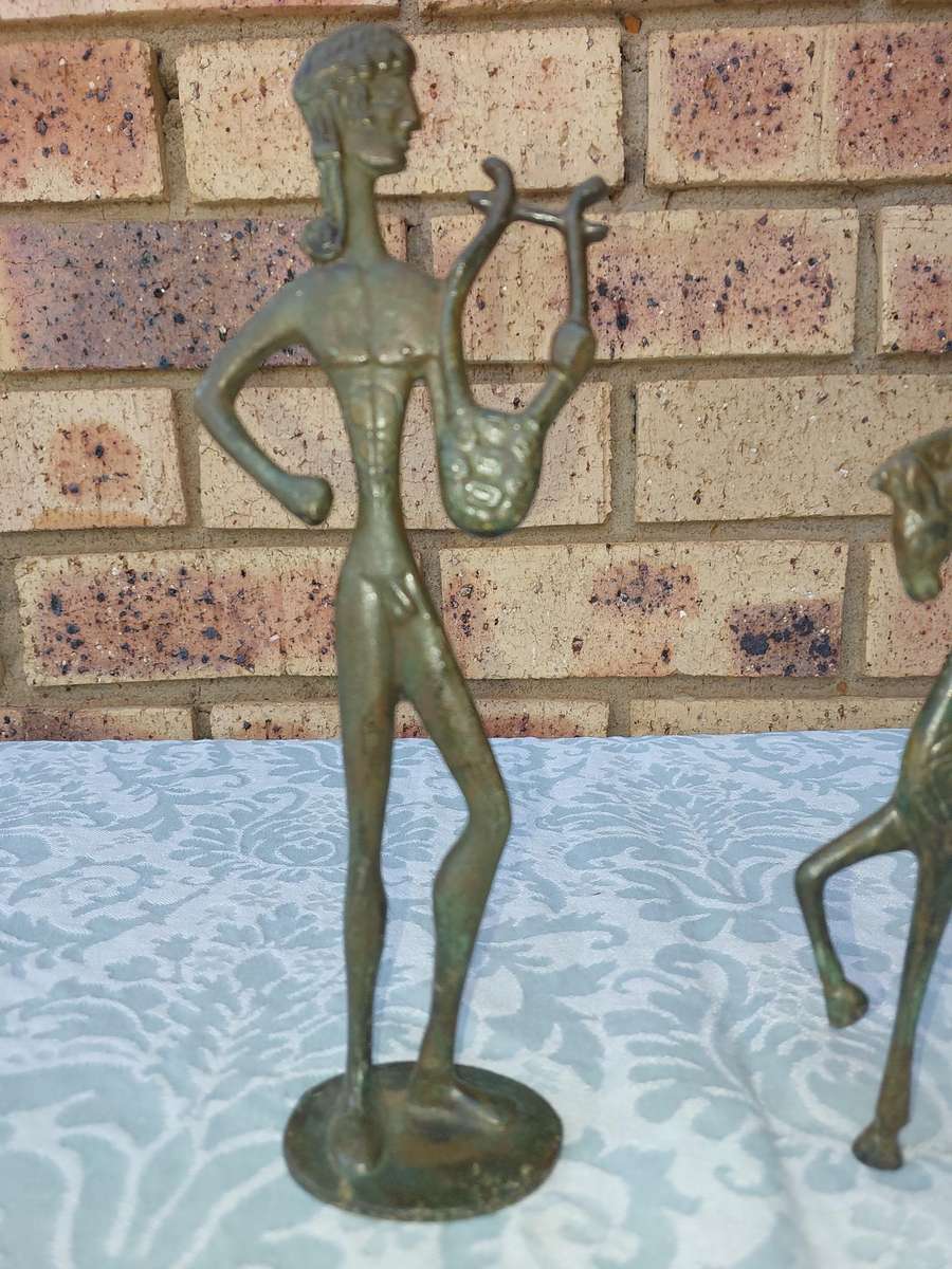 A vintage Mid Century Modern Inspired Metal Etruscan Horse and a nude Greek musician sold as is