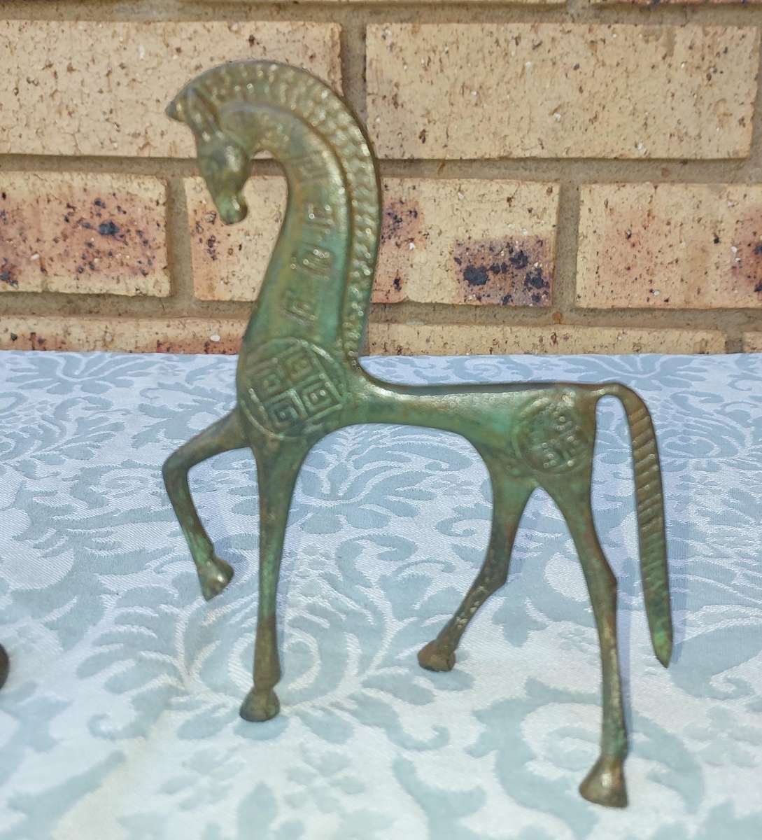 A vintage Mid Century Modern Inspired Metal Etruscan Horse and a nude Greek musician sold as is