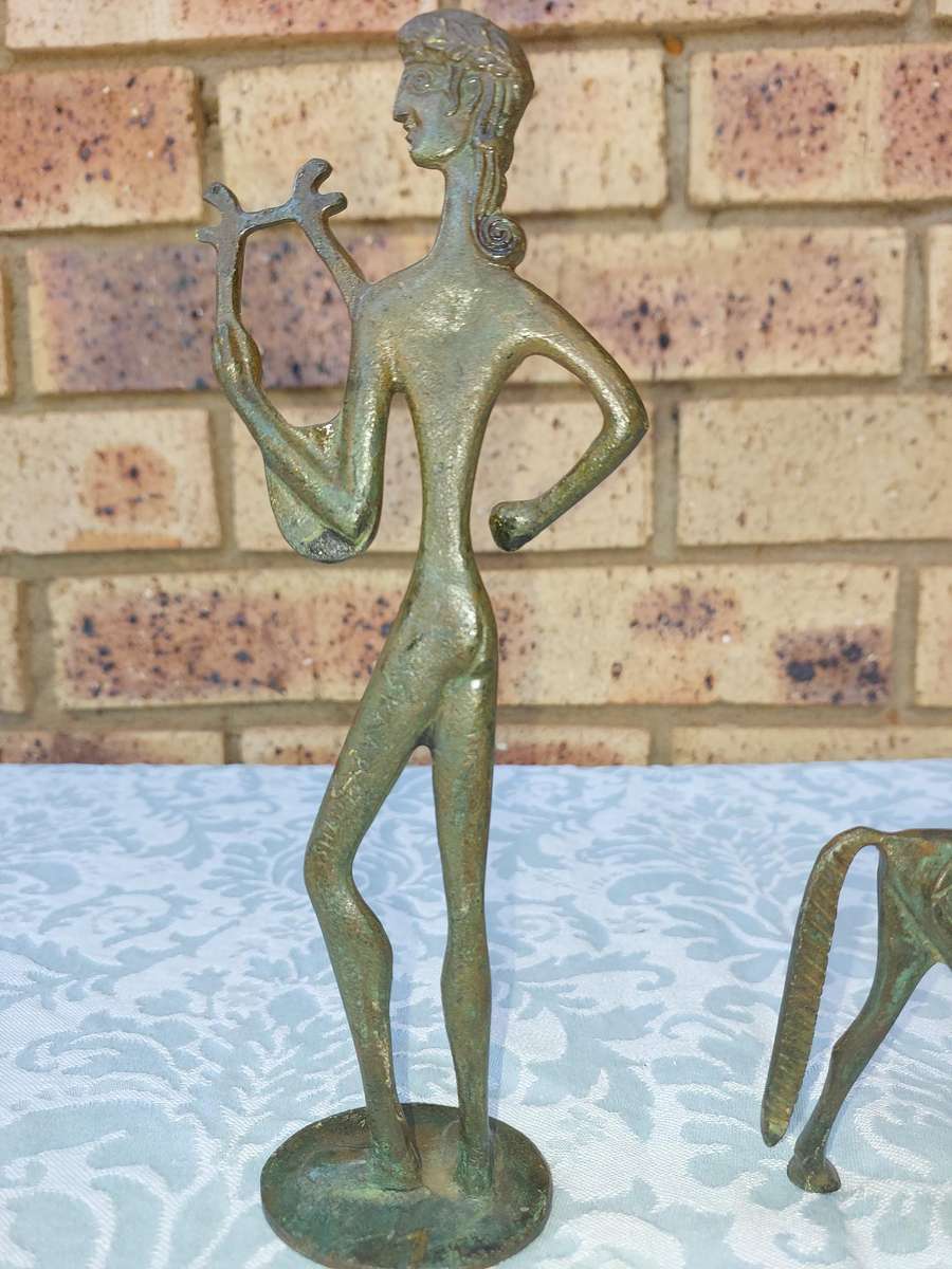 A vintage Mid Century Modern Inspired Metal Etruscan Horse and a nude Greek musician sold as is