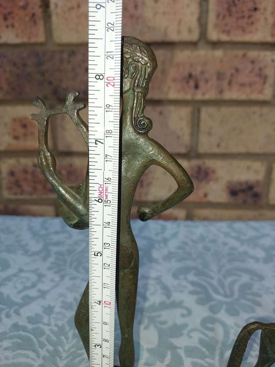 A vintage Mid Century Modern Inspired Metal Etruscan Horse and a nude Greek musician sold as is