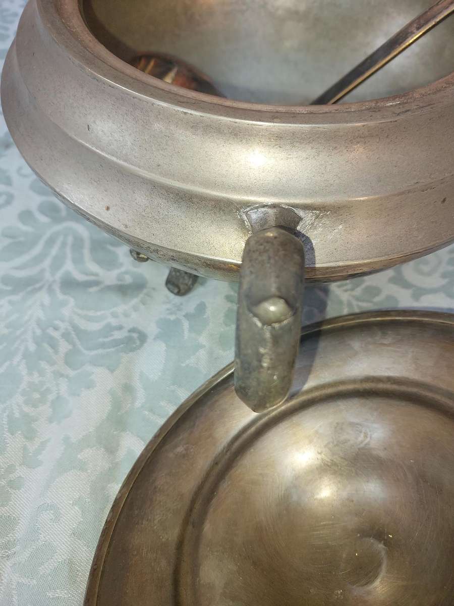 AN ANTIQUE SILVER PLATED TUREEN WITH A LADLE SOLD AS IS