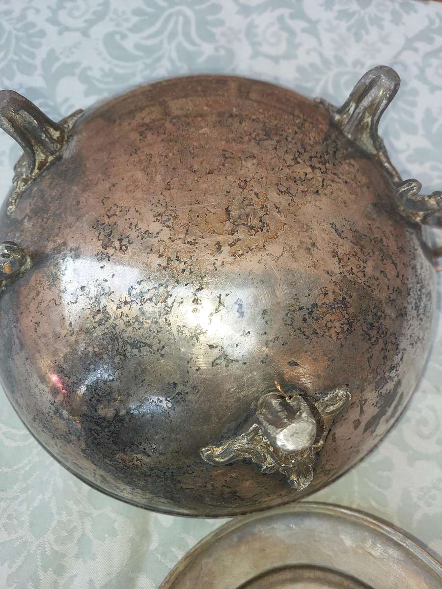 AN ANTIQUE SILVER PLATED TUREEN WITH A LADLE SOLD AS IS