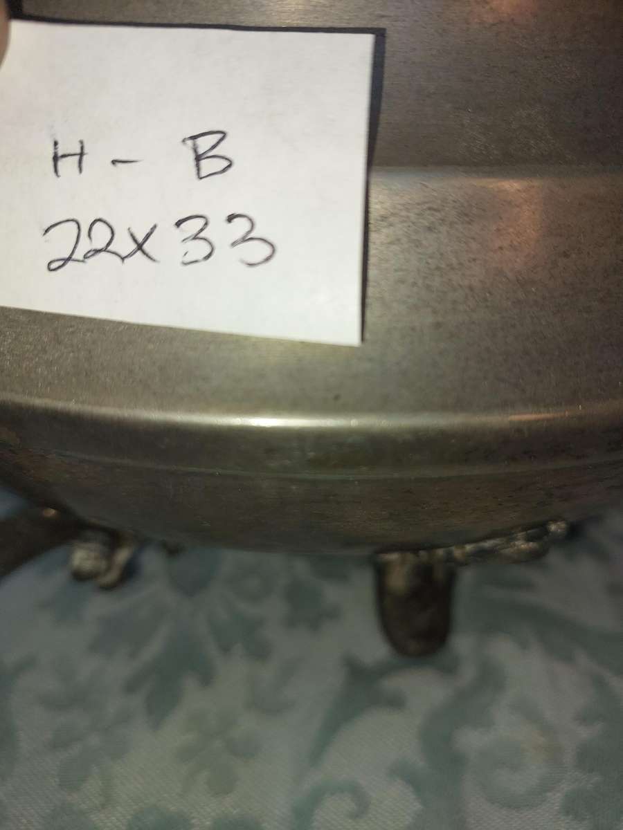 AN ANTIQUE SILVER PLATED TUREEN WITH A LADLE SOLD AS IS