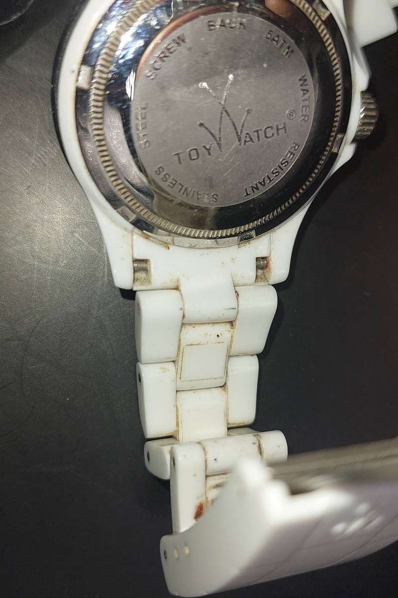 A TOY WATCHE WHITE WITH STAINLESS STEEL CLIP AND BAZEL SOLD AS IS NOT TESTED