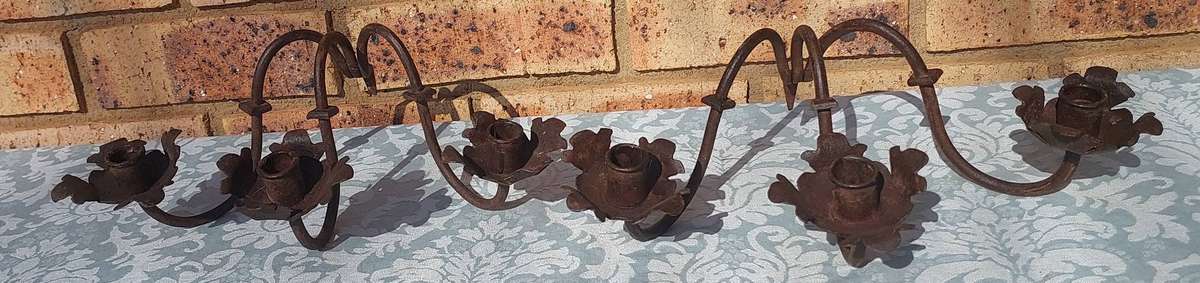 A VINTAGE  PAIR OF WRATH IRON  WALL CANDLE HOLDERS SOLD AS IS