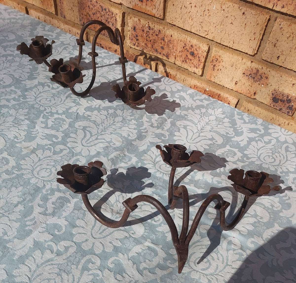 A VINTAGE  PAIR OF WRATH IRON  WALL CANDLE HOLDERS SOLD AS IS