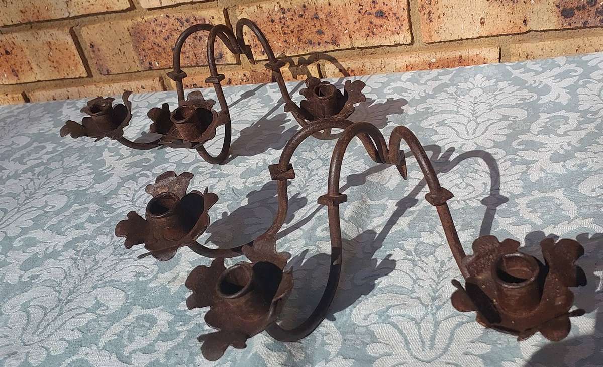 A VINTAGE  PAIR OF WRATH IRON  WALL CANDLE HOLDERS SOLD AS IS