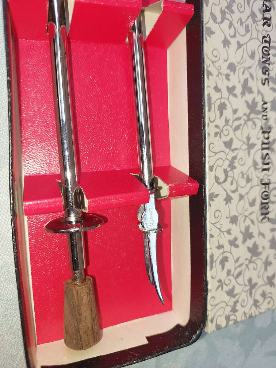 A collector's bar tongs and push fork sold as is