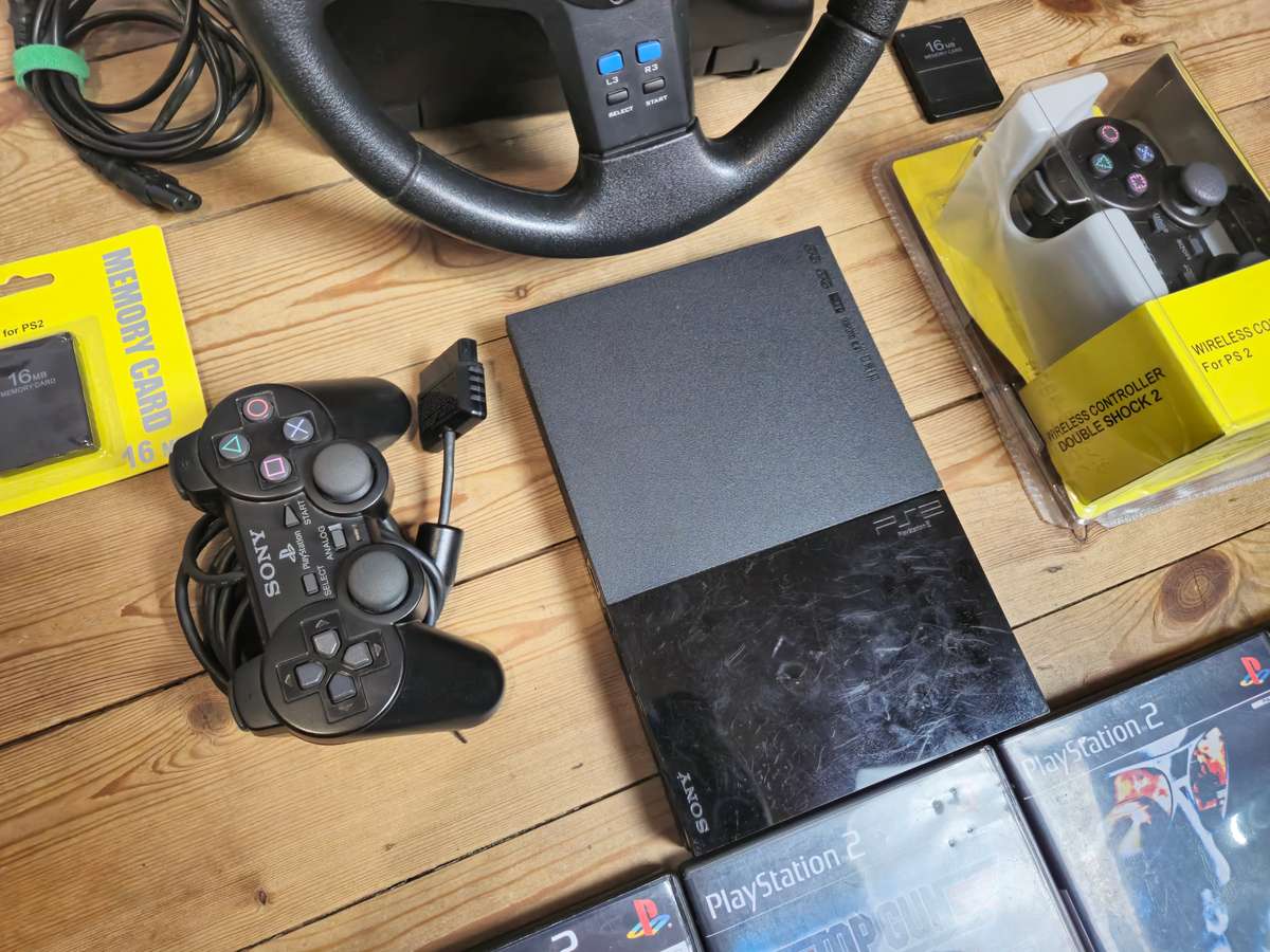 PlayStation 2 Slim Bundle with Logitech Racing Wheel, Controllers, Memory Cards & Games