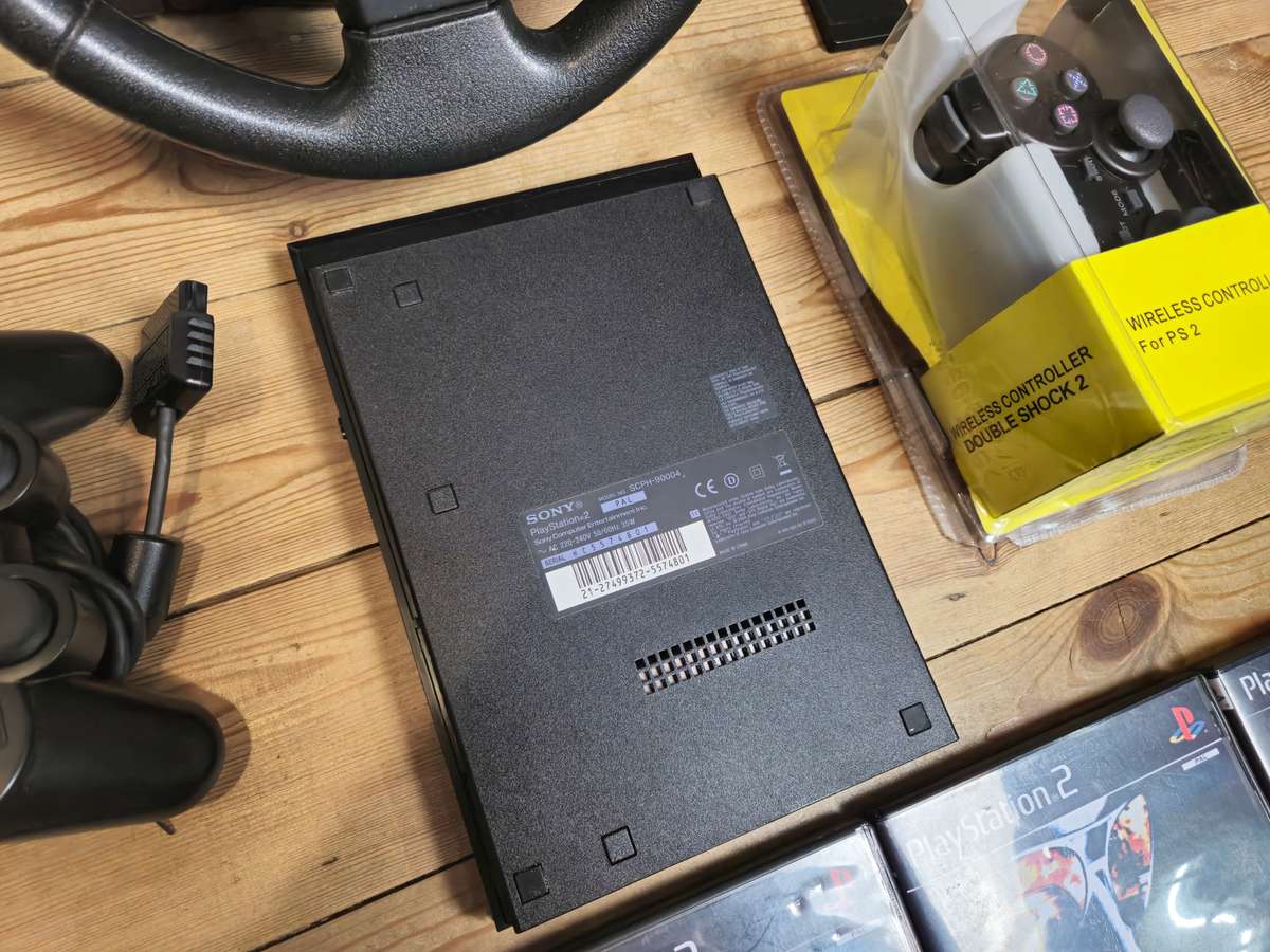 PlayStation 2 Slim Bundle with Logitech Racing Wheel, Controllers, Memory Cards & Games