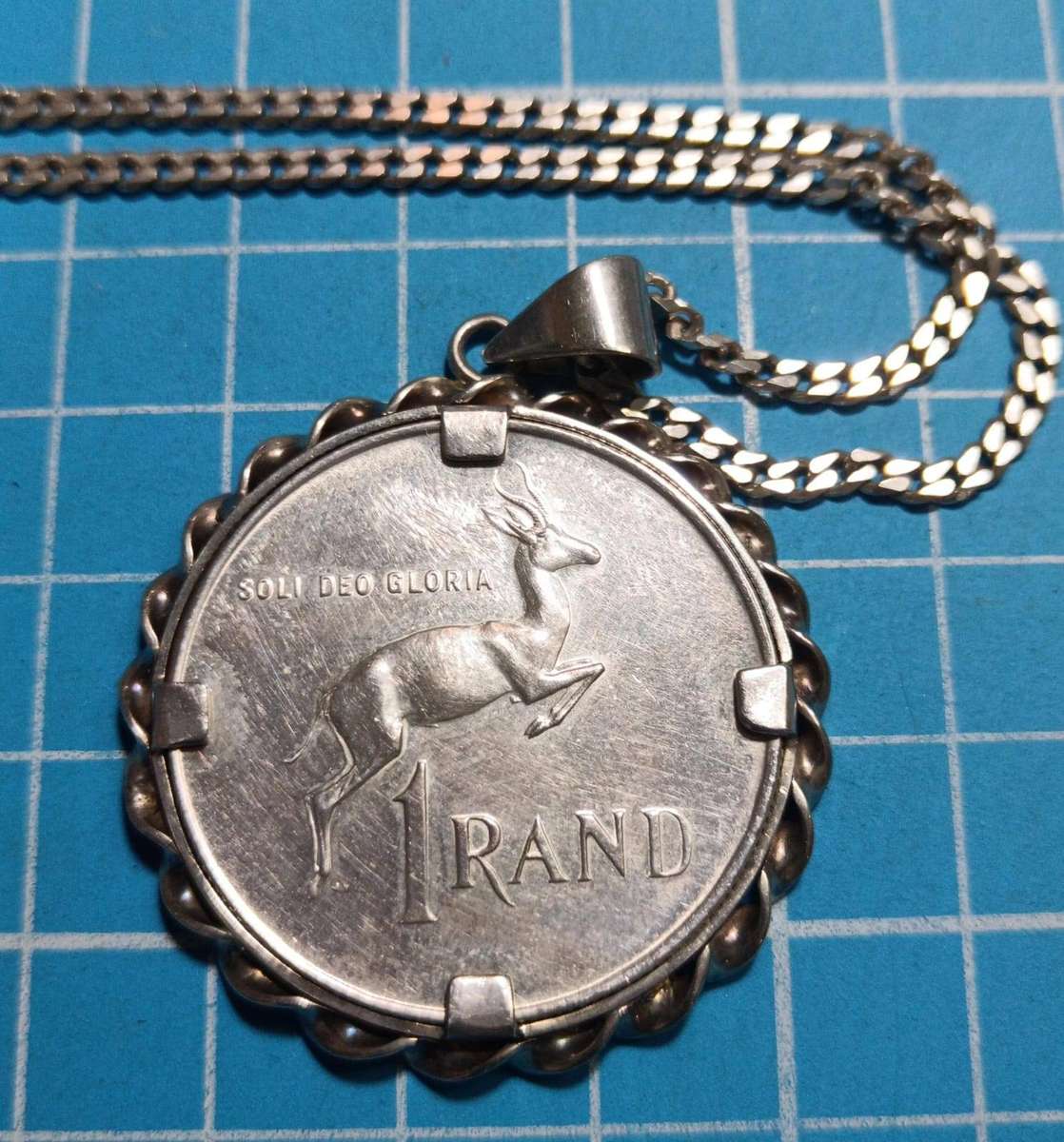 Silver R1 mounted on a silver chain