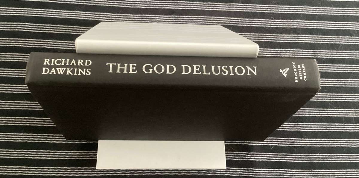 THE GOD DELUSION by Richard Dawkins. Hardback, silver cover edition, in an excellent condition.
