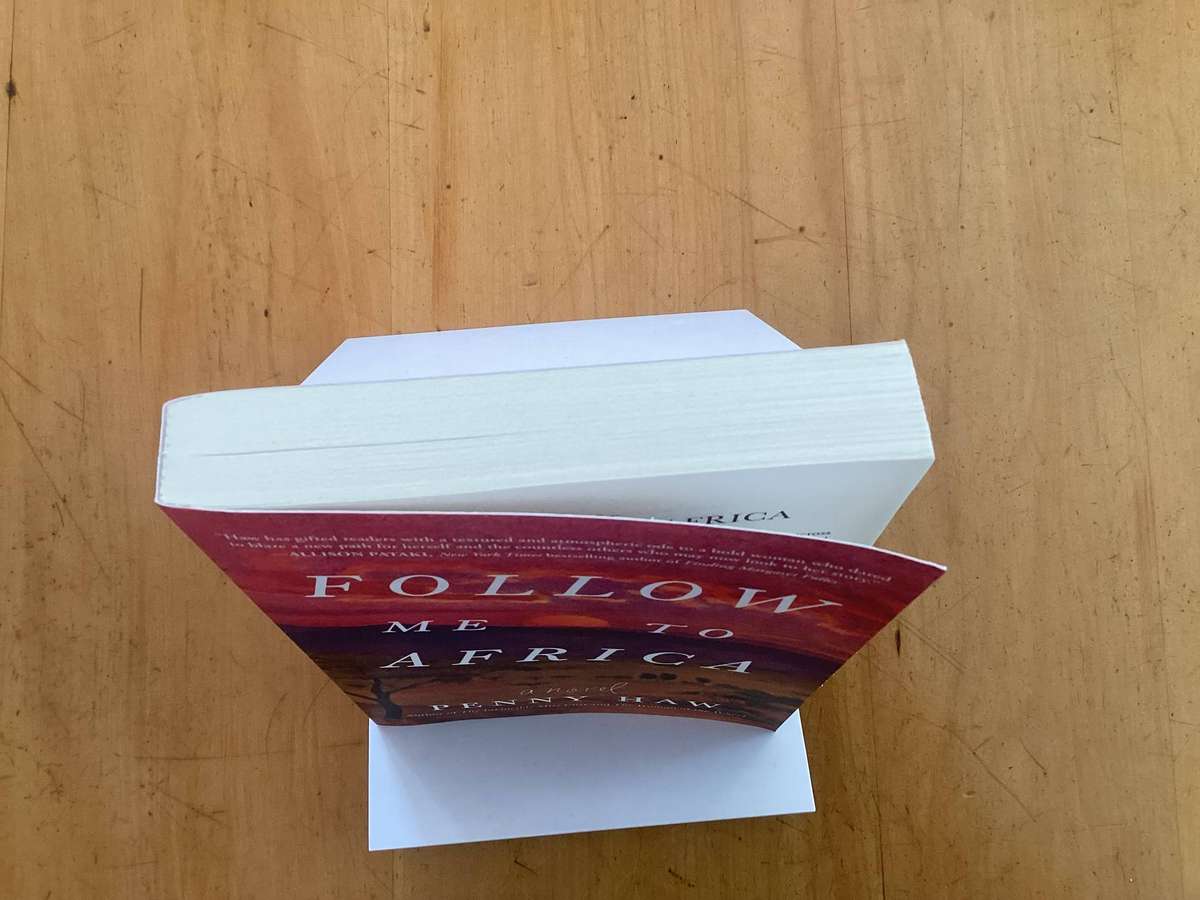 FOLLOW ME TO AFRICA. A novel by Penny Haw. Paperback in a new condition.