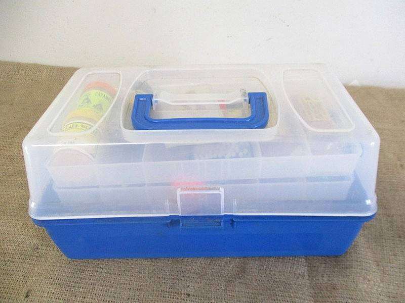 A Plastic Toolbox With A Variety Of Various Fishing Tackle Equipment