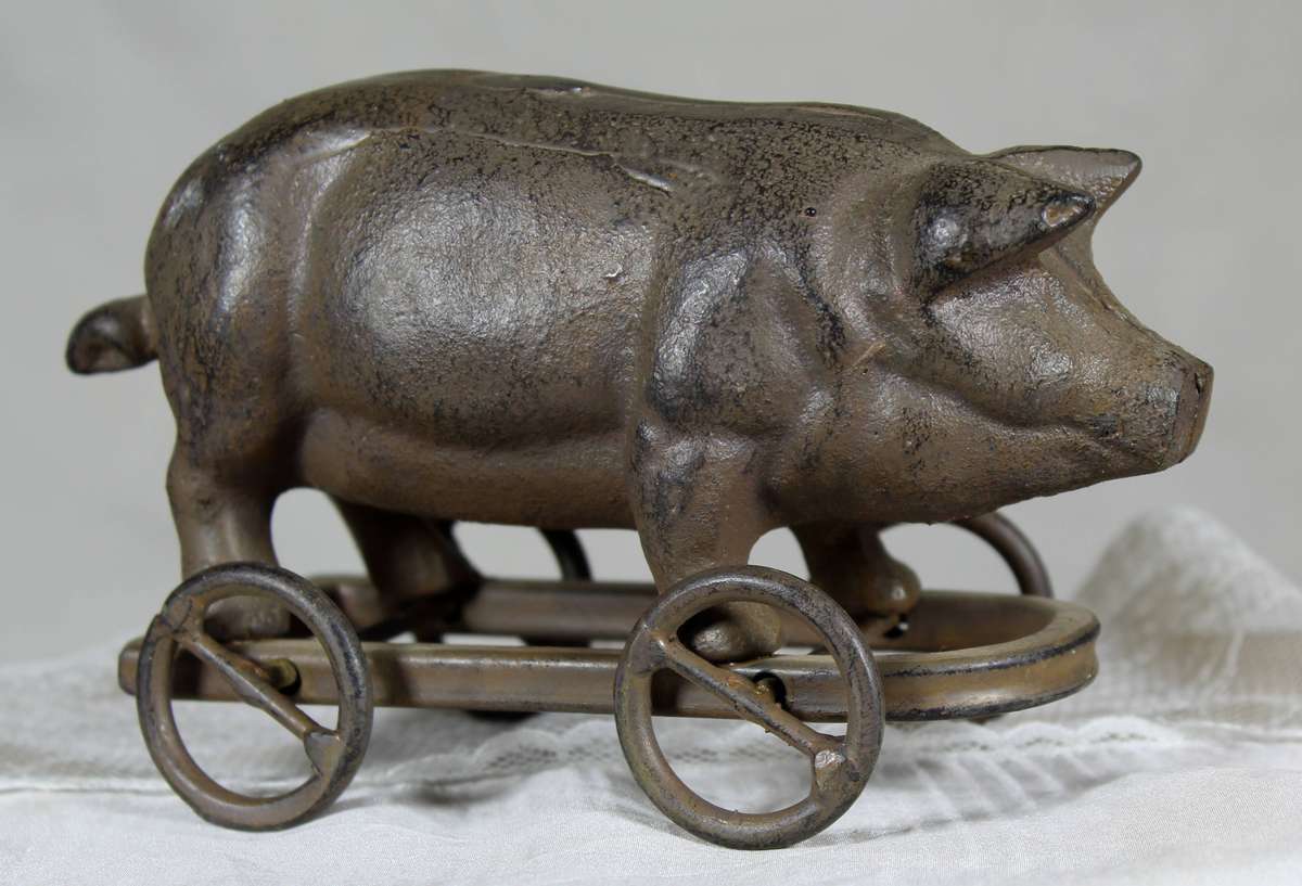 Vintage cast metal pig on wheels