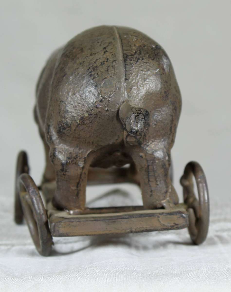 Vintage cast metal pig on wheels