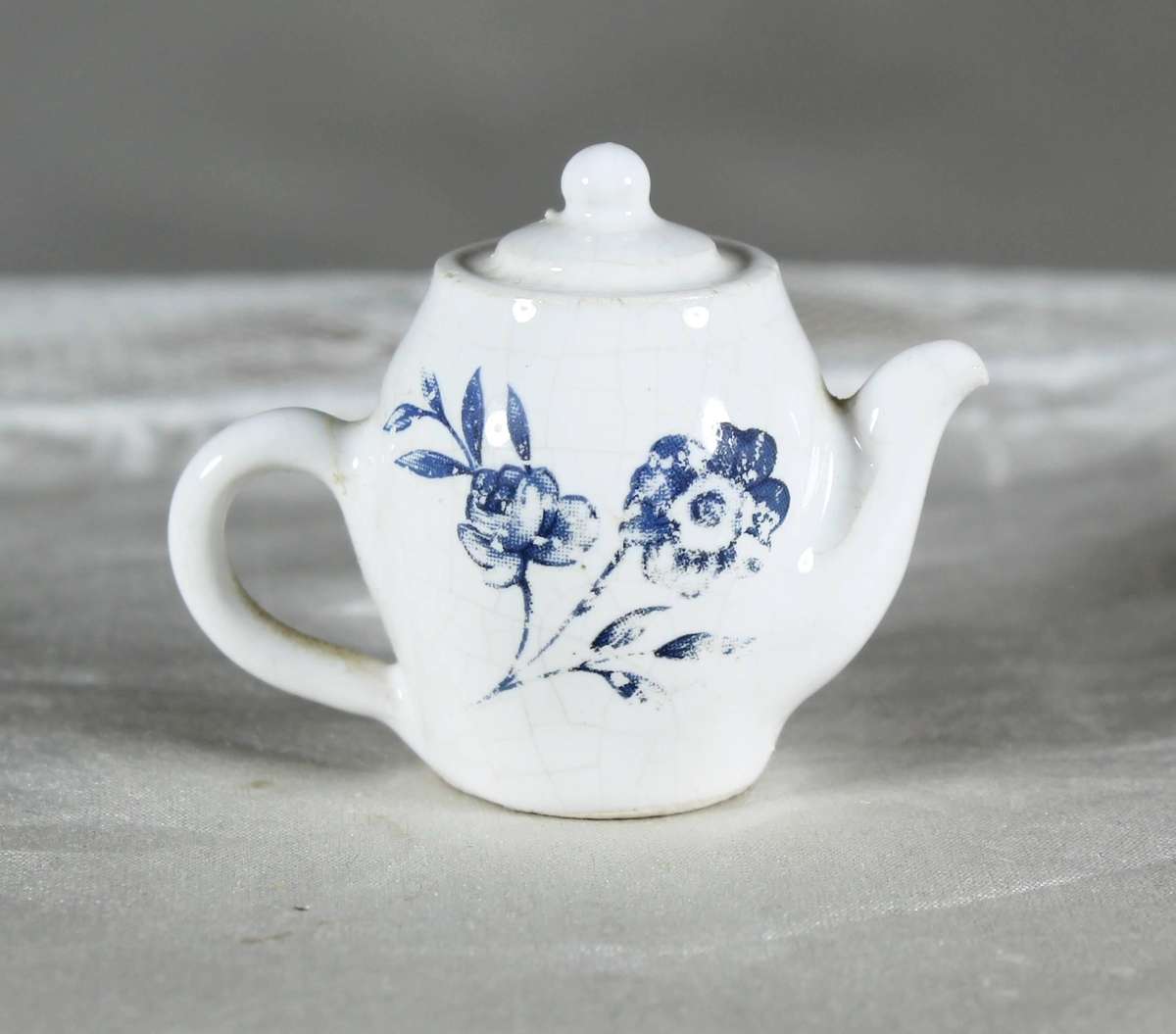 Miniature porcelain kettle with flowers