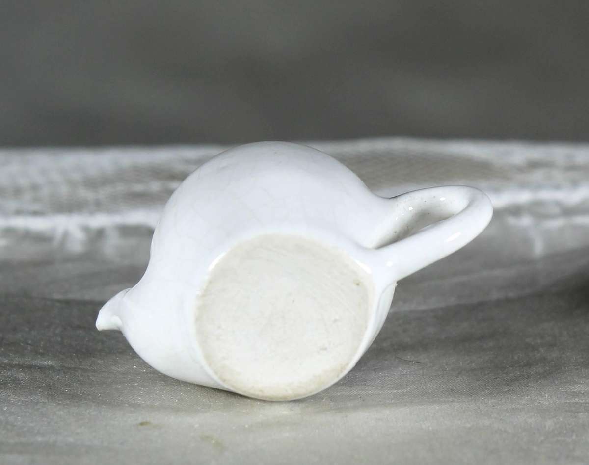 Miniature porcelain kettle with flowers