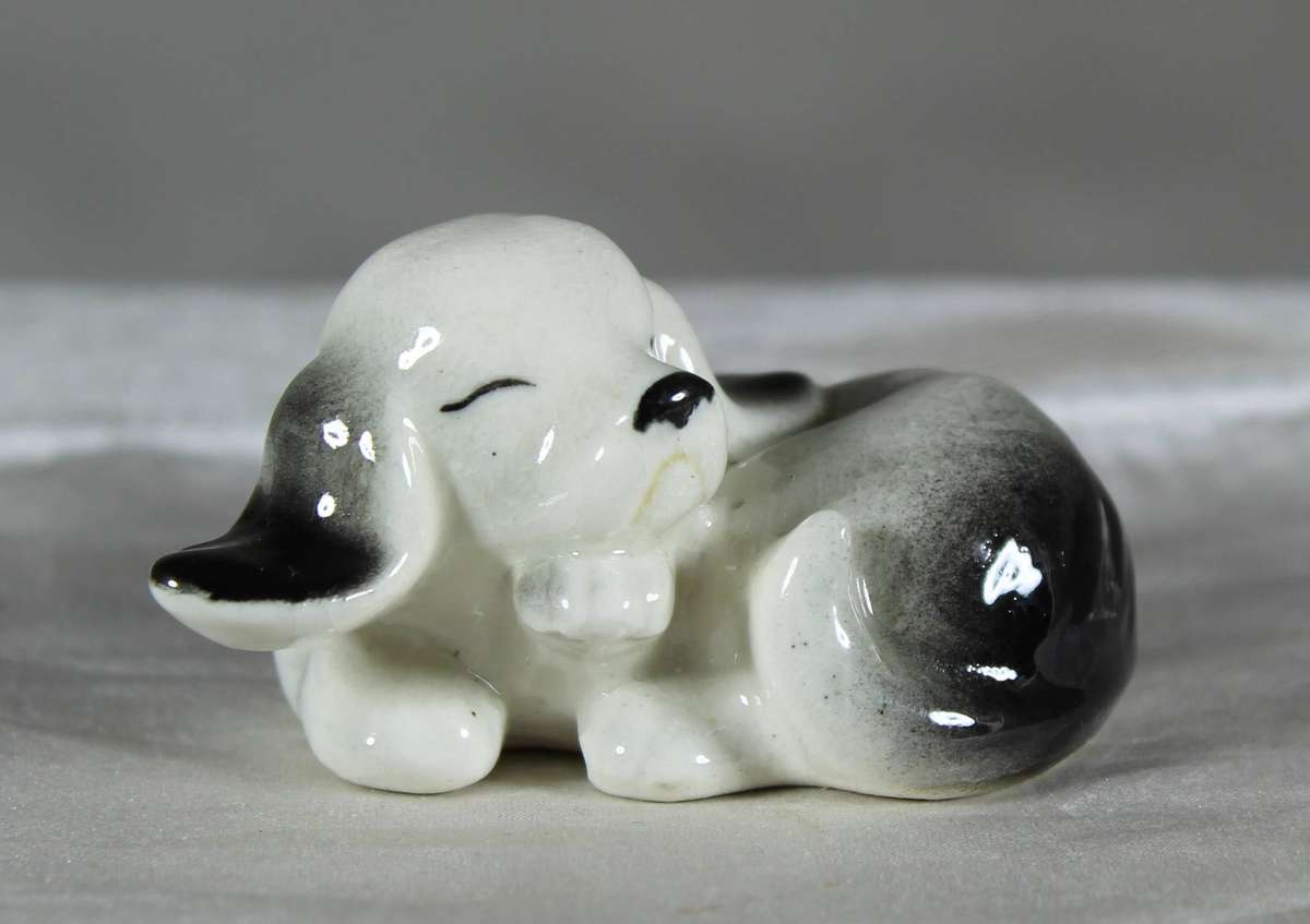Miniature porcelain sleeping dog