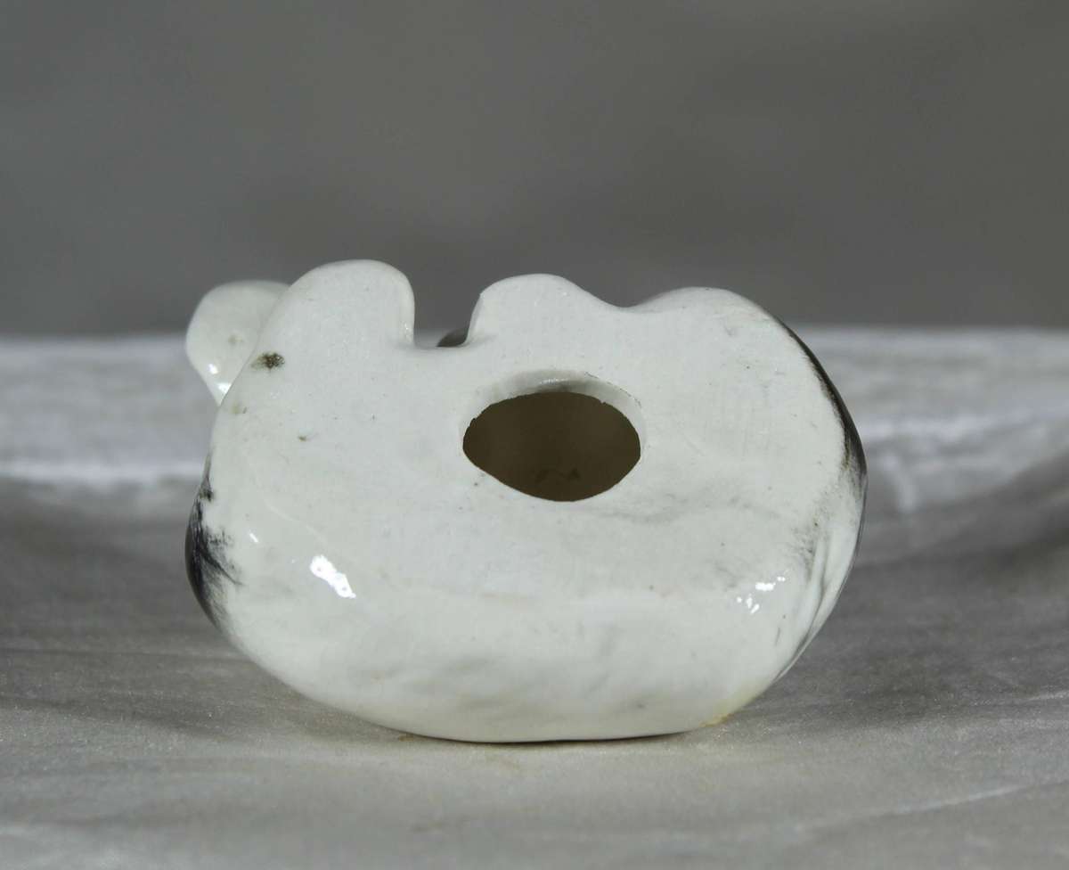 Miniature porcelain sleeping dog