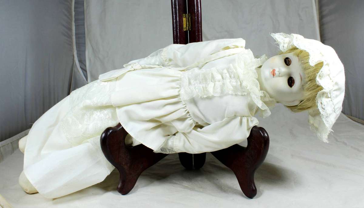 Vintage porcelain doll dressed in her Sunday's best