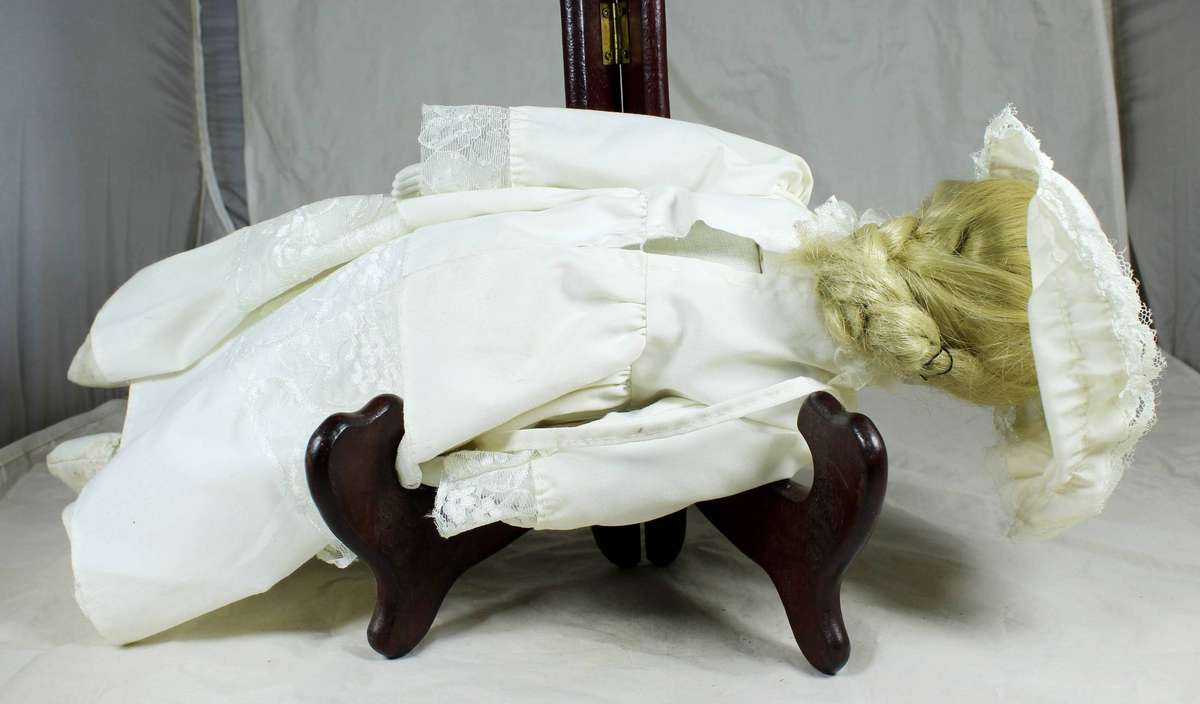 Vintage porcelain doll dressed in her Sunday's best
