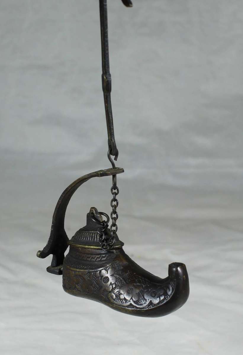 Vintage brass oil lamp in a boot shape
