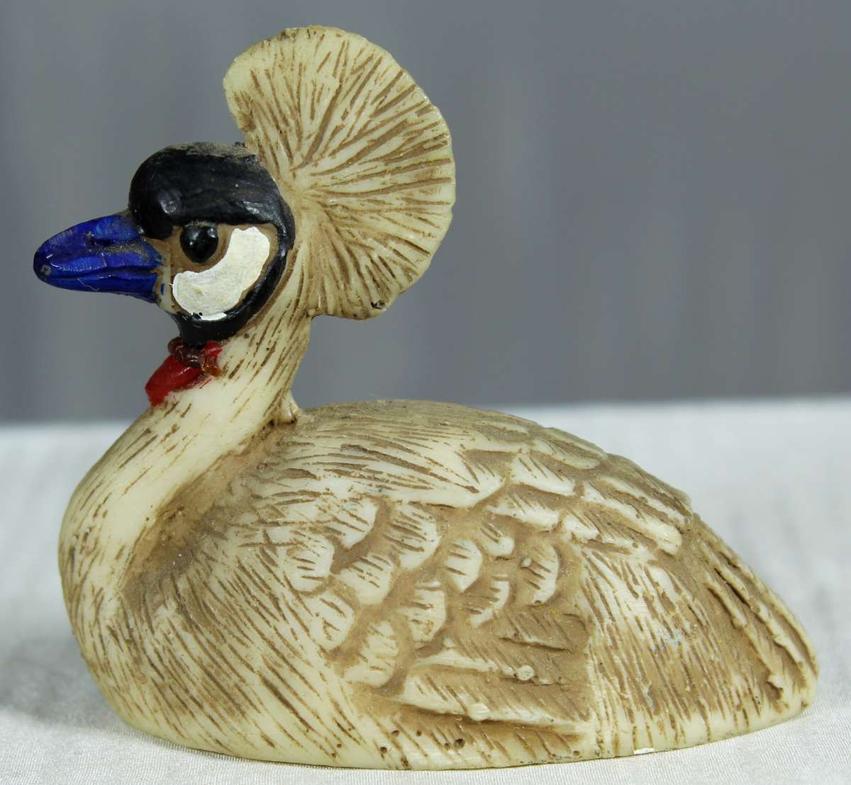 Miniature grey crowned crane figurine