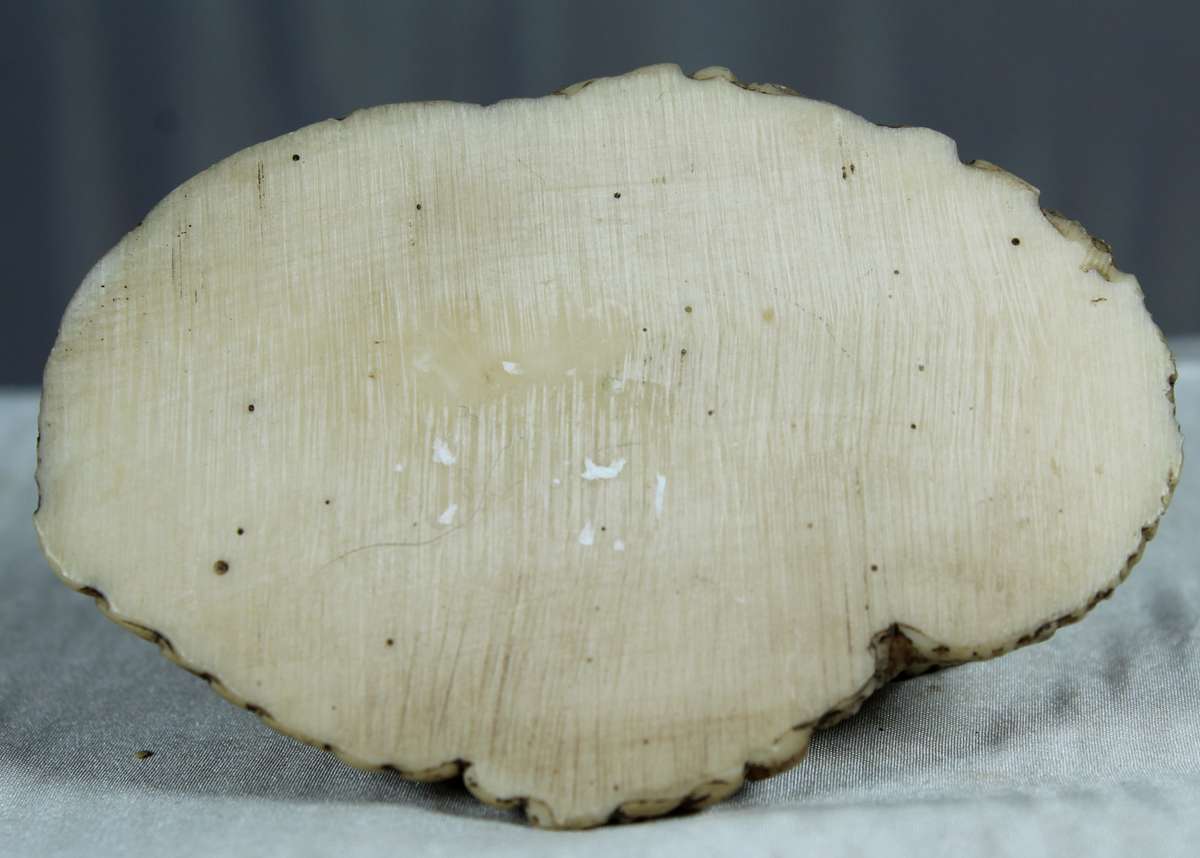 Miniature African huts with people sitting in front