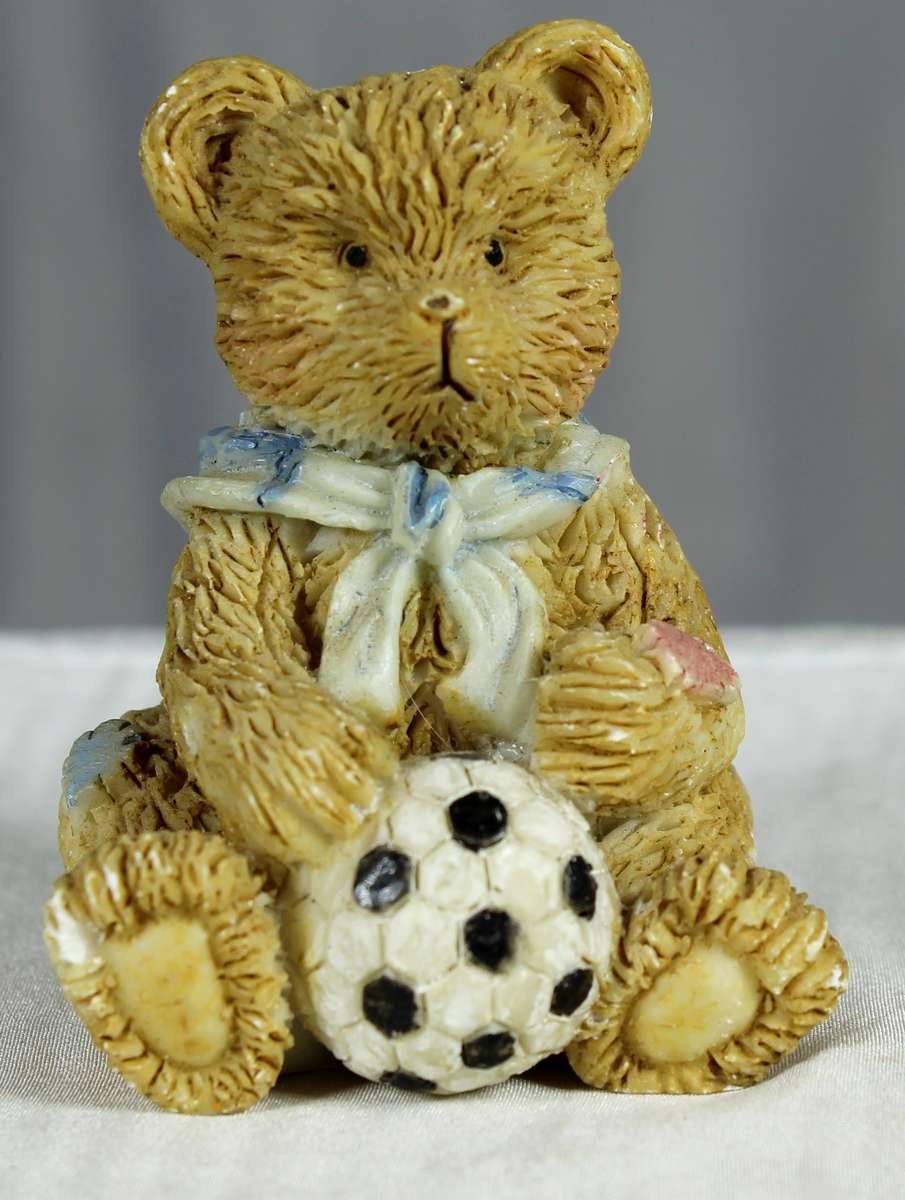 Little boy bear with soccer ball