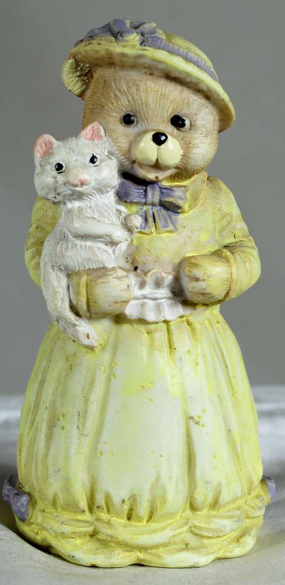 Mamma bear holding a kitty figurine
