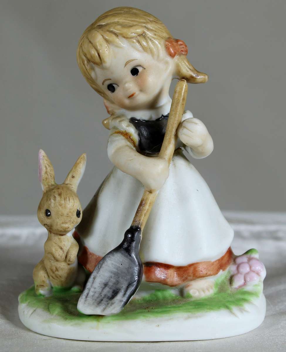 Little girl with a broom plus a rabbit