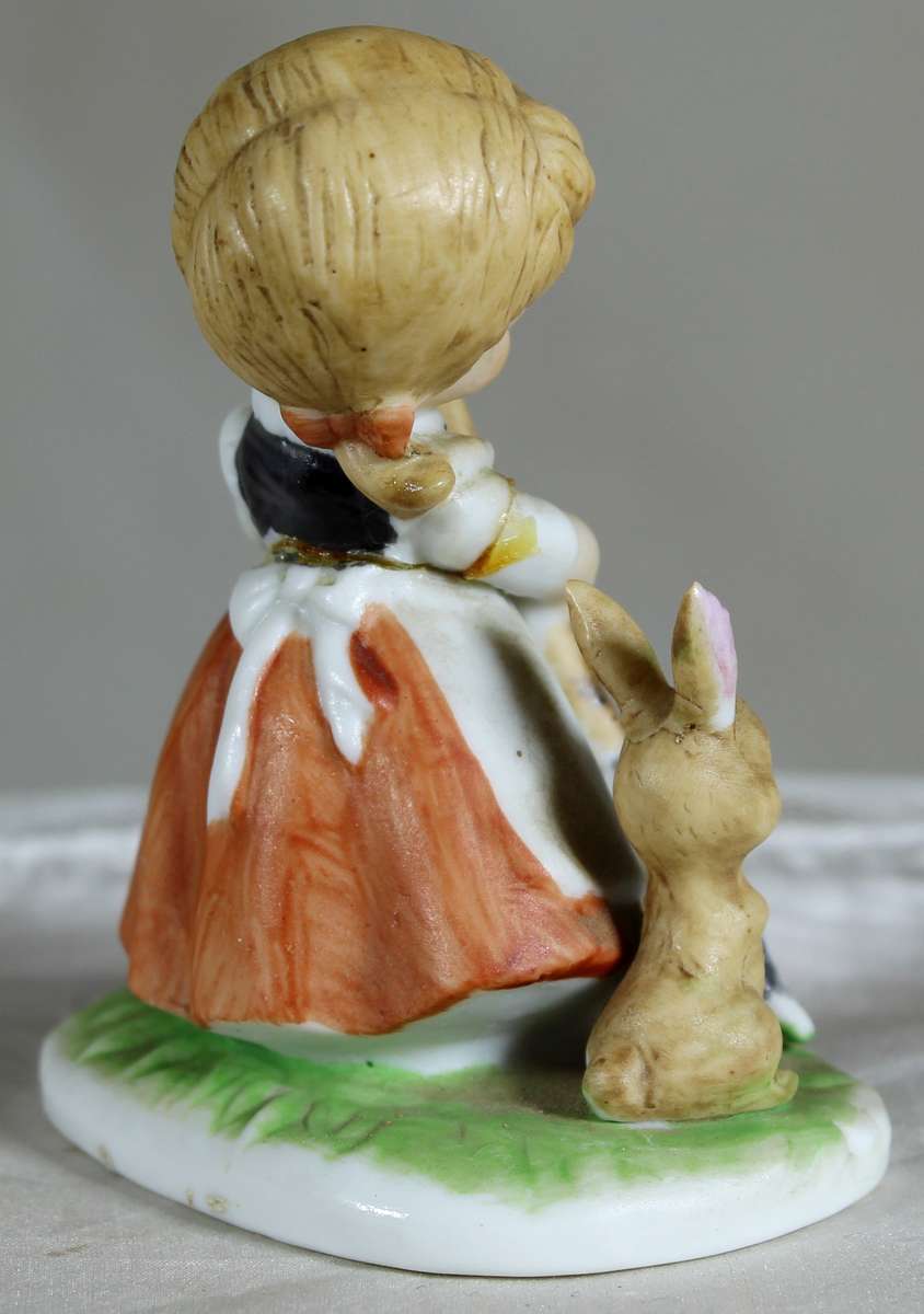 Little girl with a broom plus a rabbit