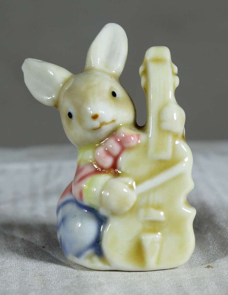 Miniature glazed ceramic bunny playing a bass - white ears
