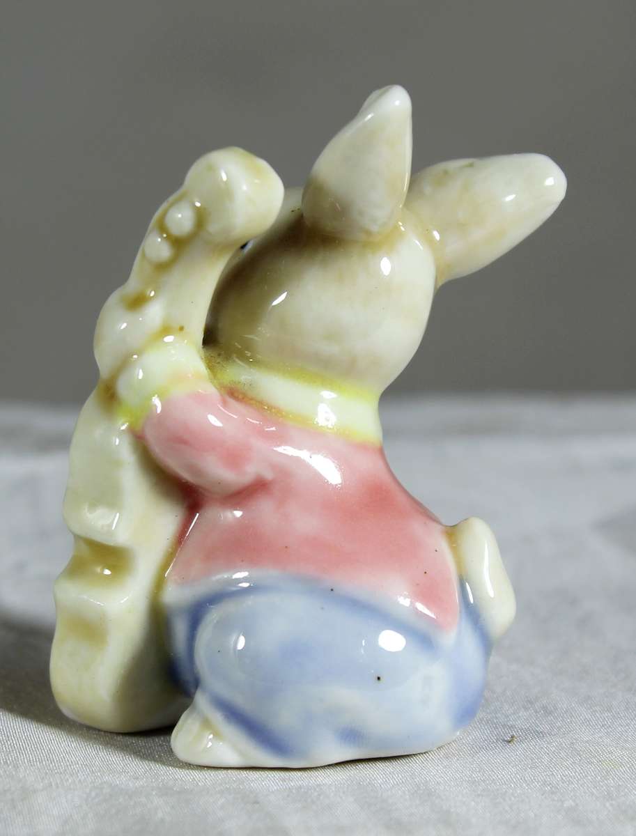 Miniature glazed ceramic bunny playing a bass - white ears