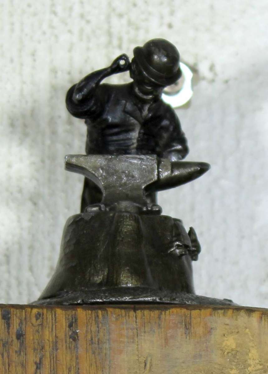 Vintage wind velocity meter with metal anvil worker figurine