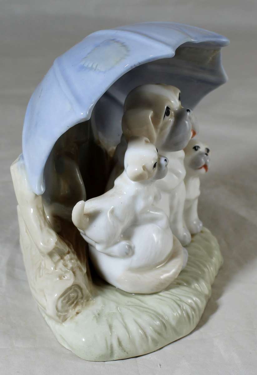 Porcelain dog with puppies under an umbrella