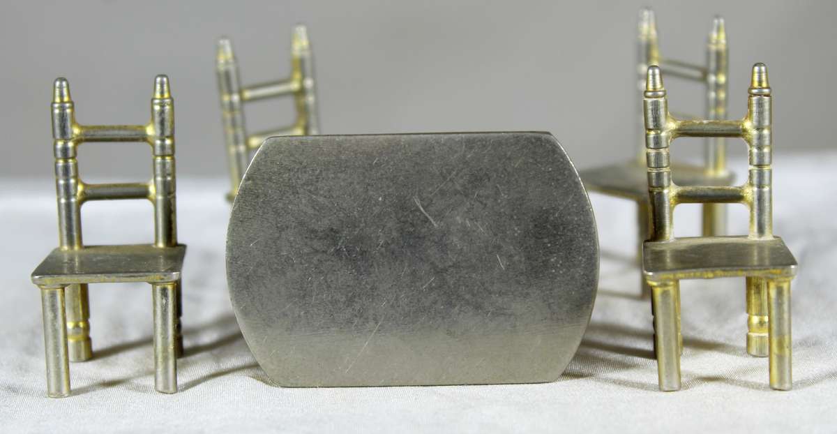 Miniature brass table with four chairs