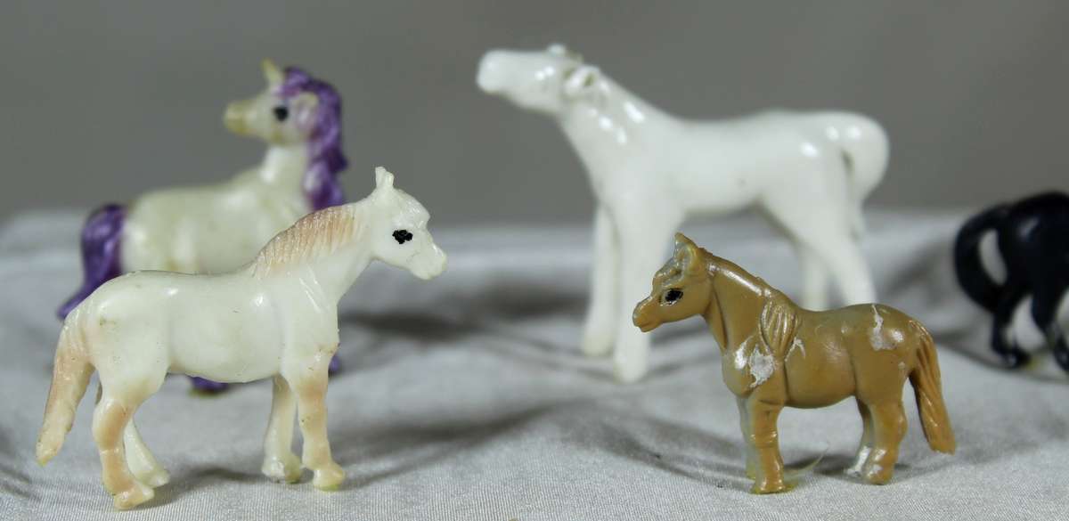 Set of six miniature horses - plastic and one glass
