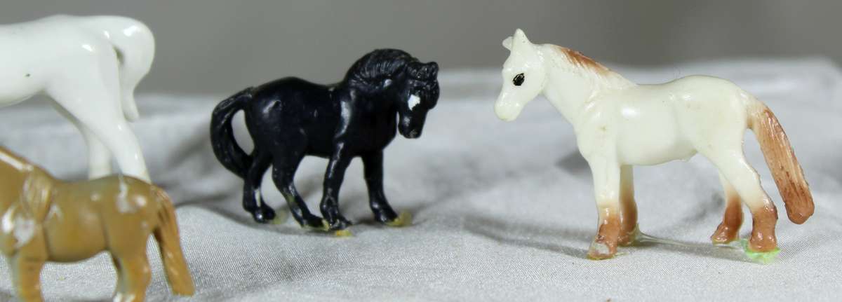 Set of six miniature horses - plastic and one glass
