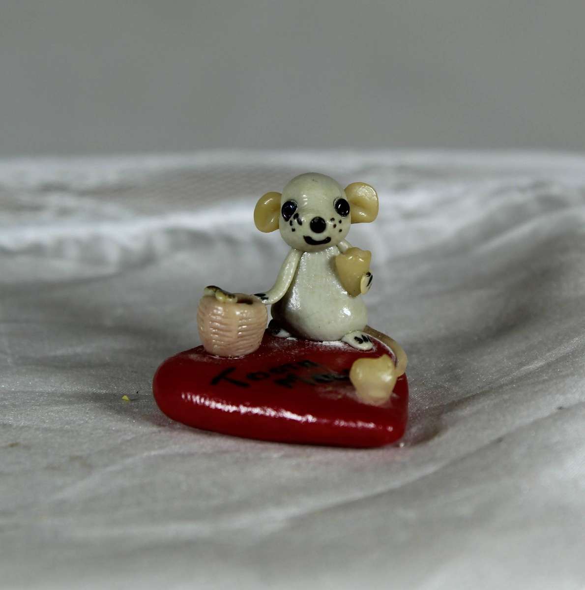 Mini miniature tooth mouse on a heart