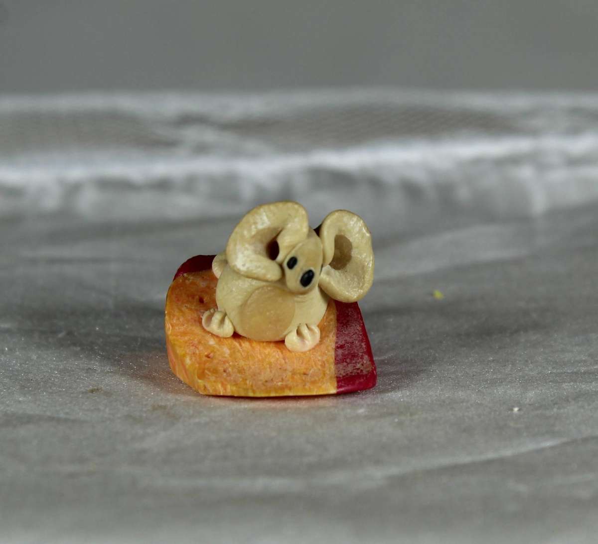 Mini miniature mouse on a slice of cheese