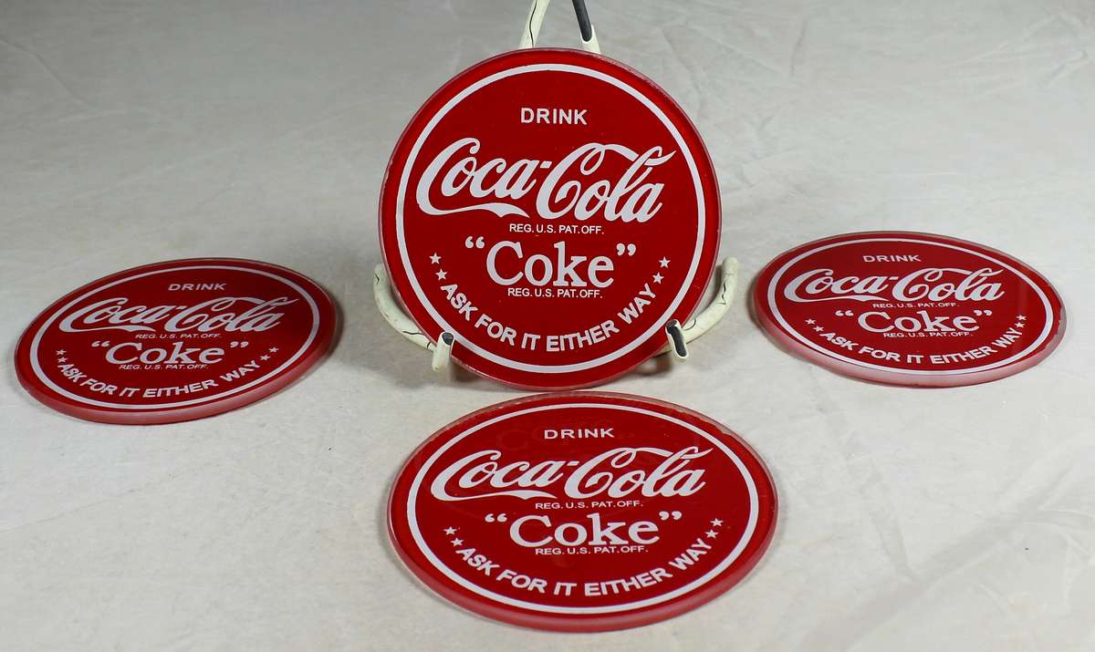 Four glass Coca-Cola coasters