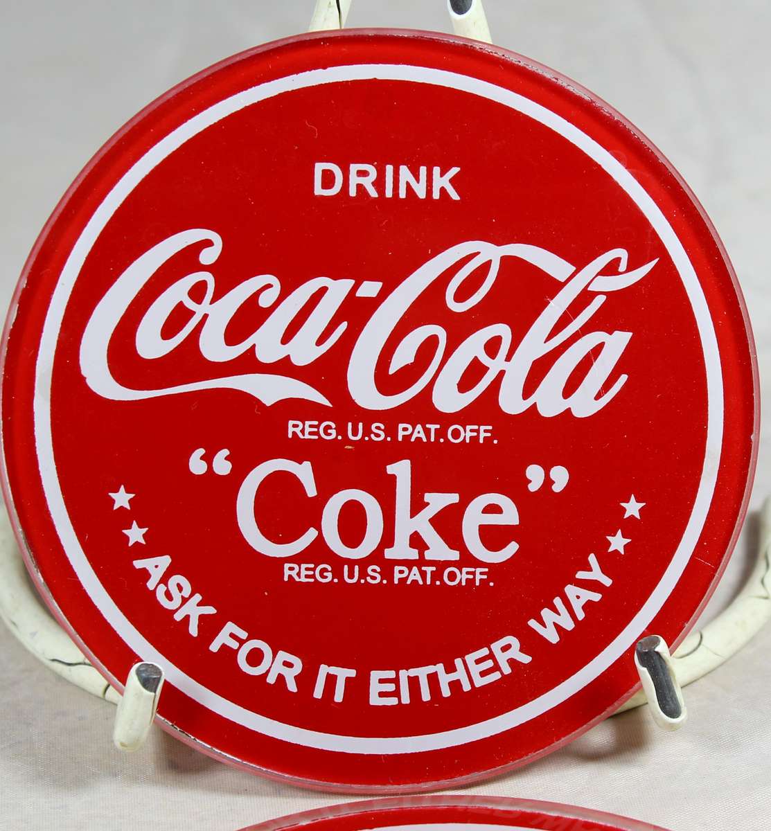Four glass Coca-Cola coasters