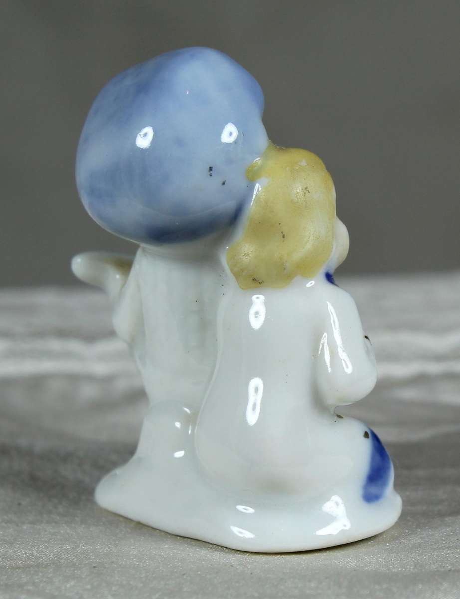 Miniature porcelain singing boy and girl