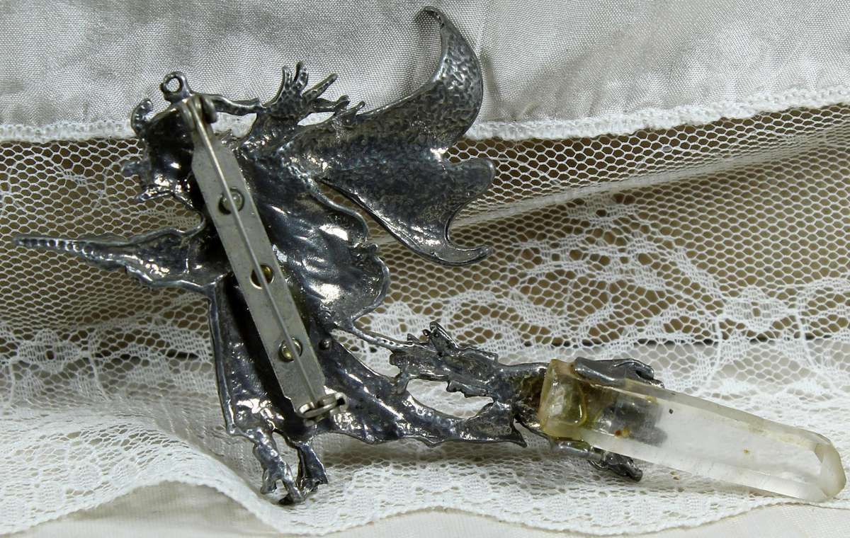 Large metal brooch of a witch with crystal