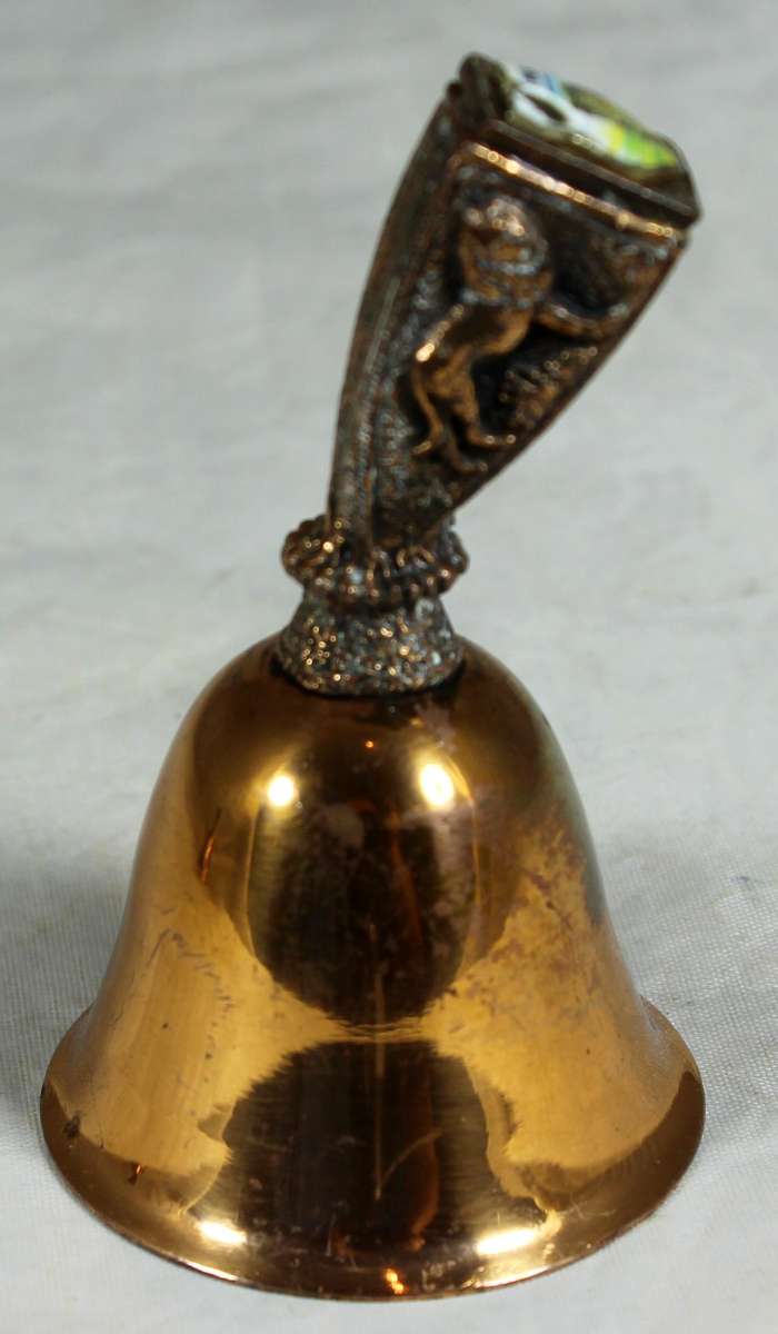 Souvenir copper bell - Kruger park with lion topped figure embossed to shield