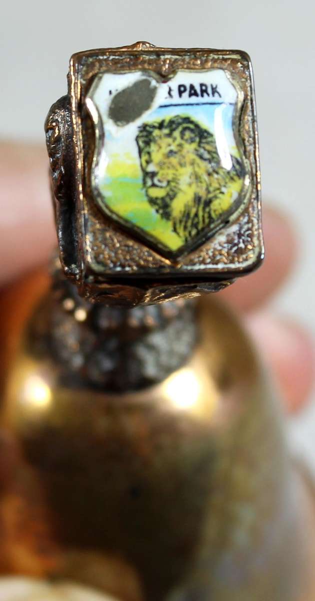 Souvenir copper bell - Kruger park with lion topped figure embossed to shield